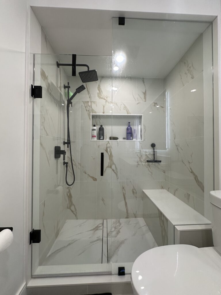 Bright tiled shower renovation with built-in storage