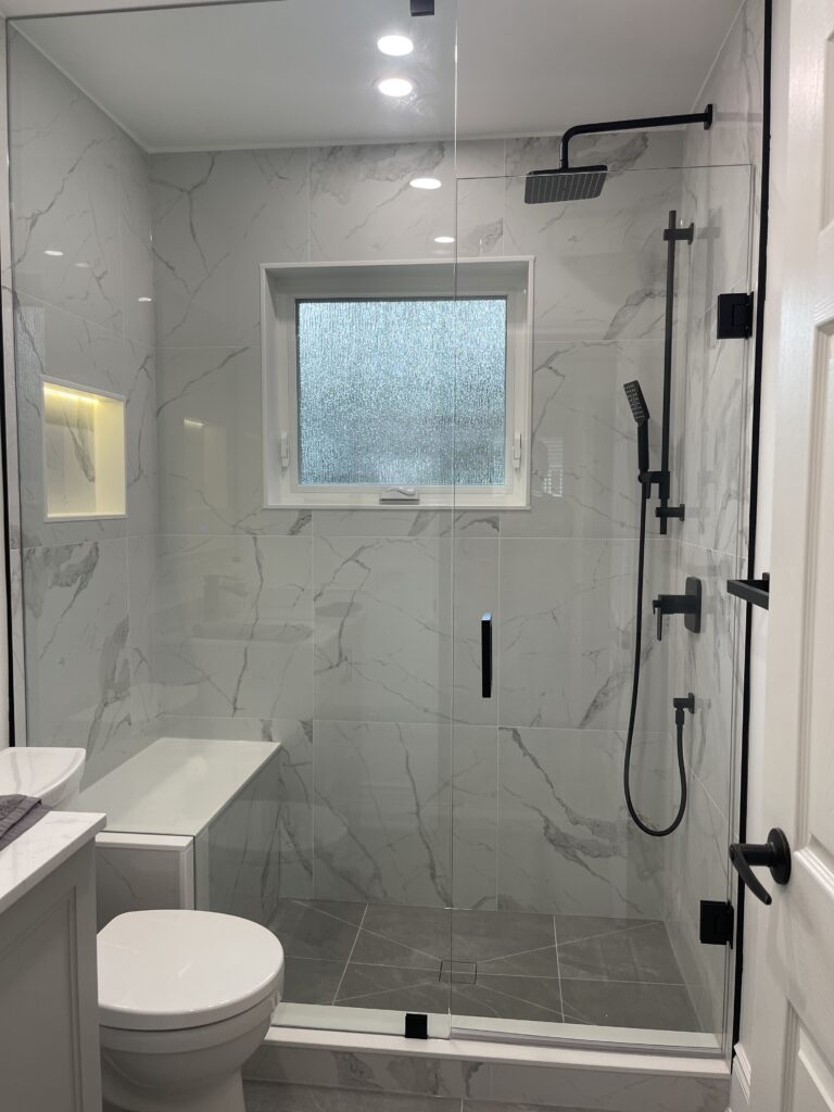 Frameless glass shower in a finished bathroom renovation